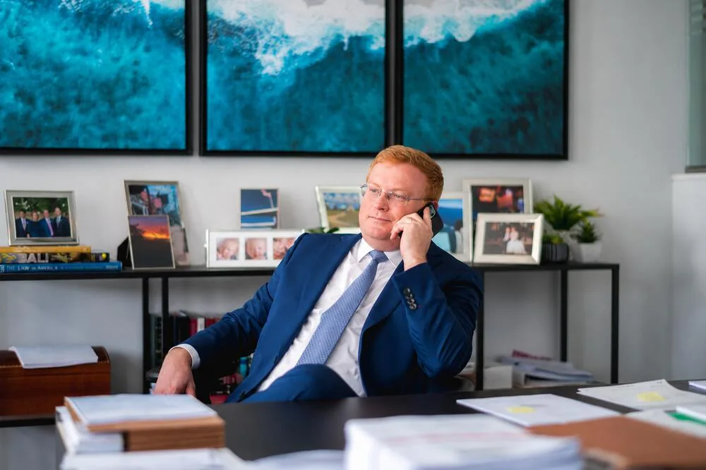 Criminal defense attorney taking a client call at a desk